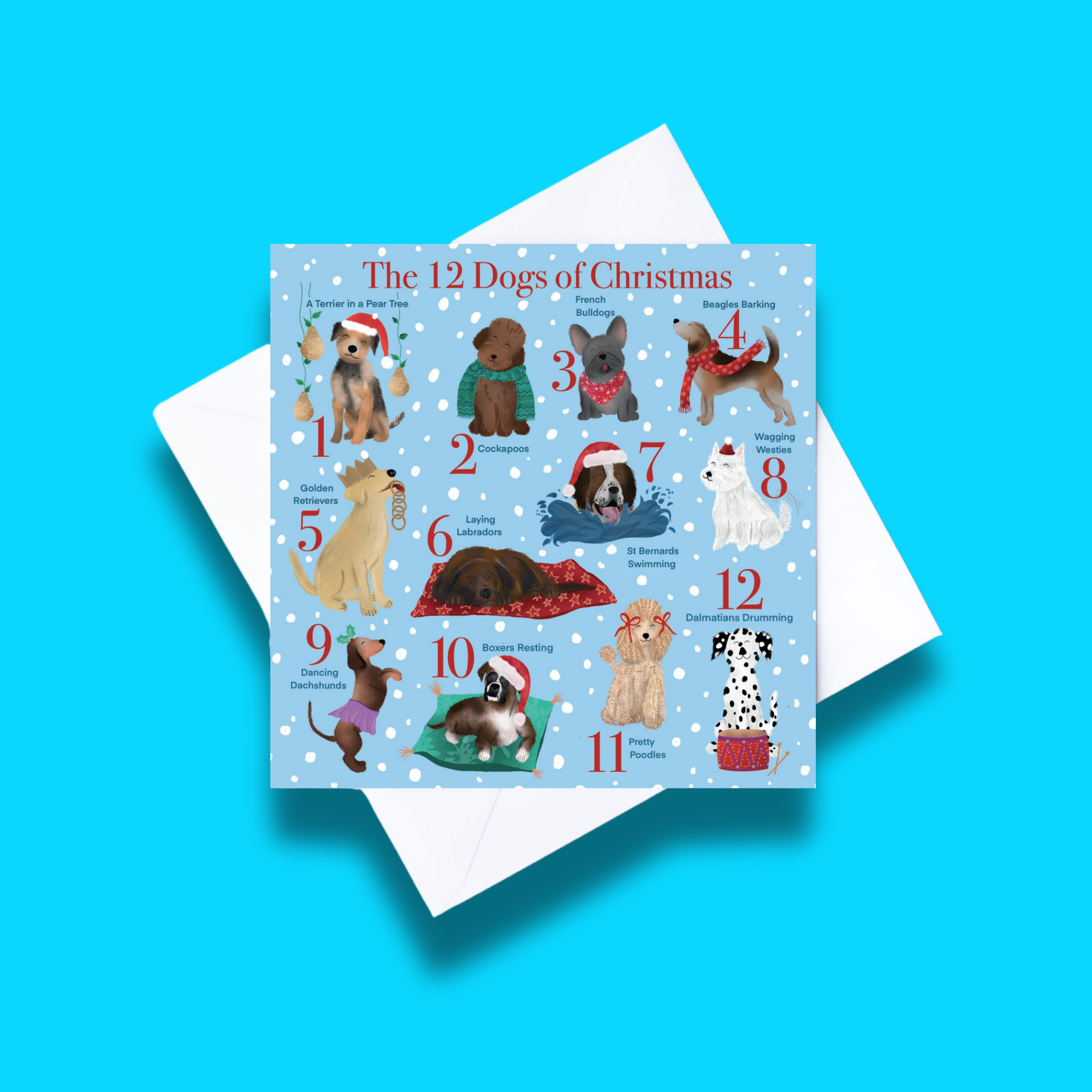 12 Dogs of Christmas Christmas card with white envelope on a blue background. Card design features 12 festive dogs depicting a different Christmas theme with puns