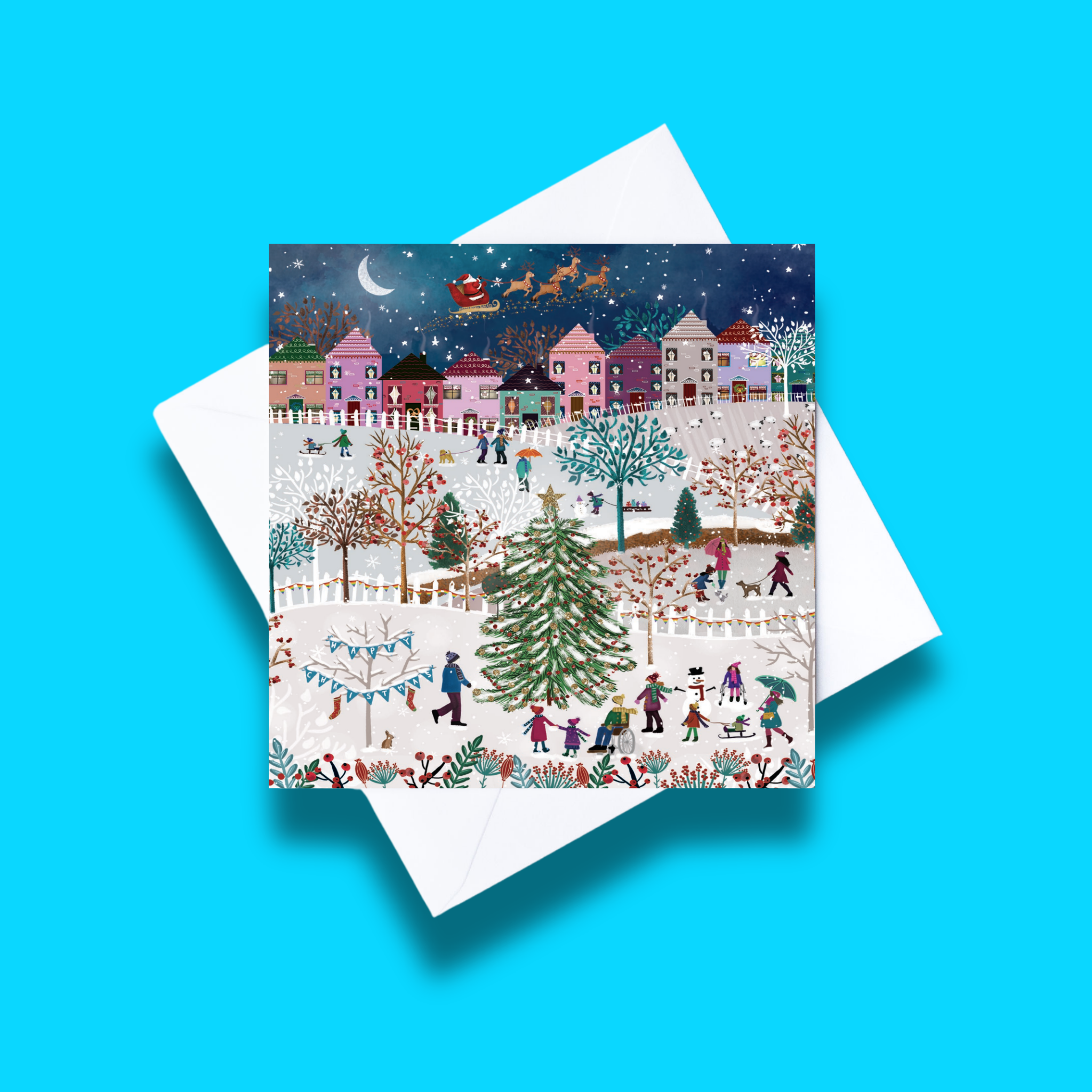 Special delivery Christmas card with white envelope on a blue background. Card design features a village during Christmas time with a large Christmas tree and people doing various activities