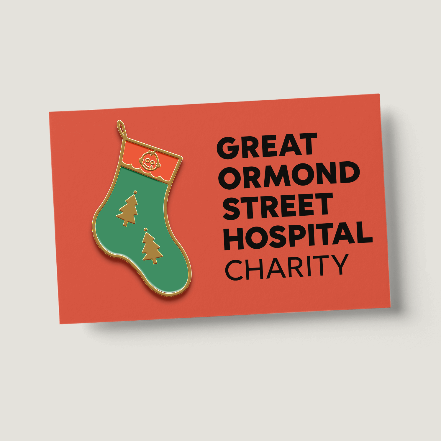 a stocking shaped pin badge on red backing card